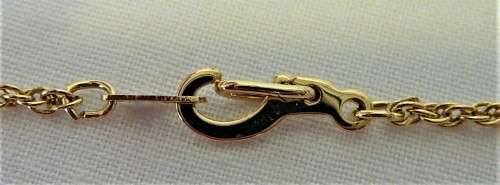 A Gold Coloured Cross on a Chain
