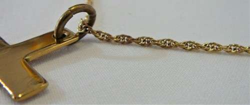 A Gold Coloured Cross on a Chain