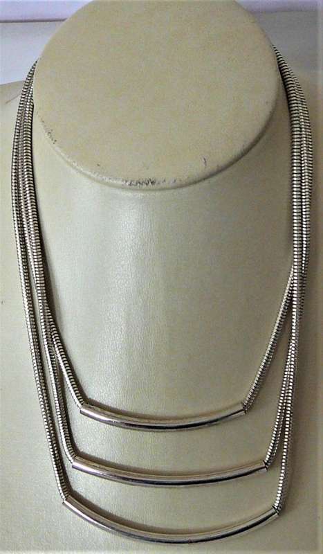 An Elegant Three Chain Silver Coloured Necklace