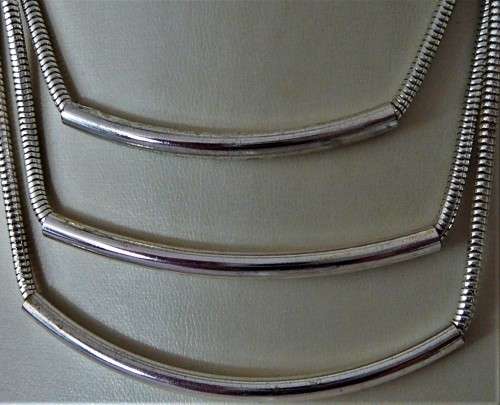 An Elegant Three Chain Silver Coloured Necklace