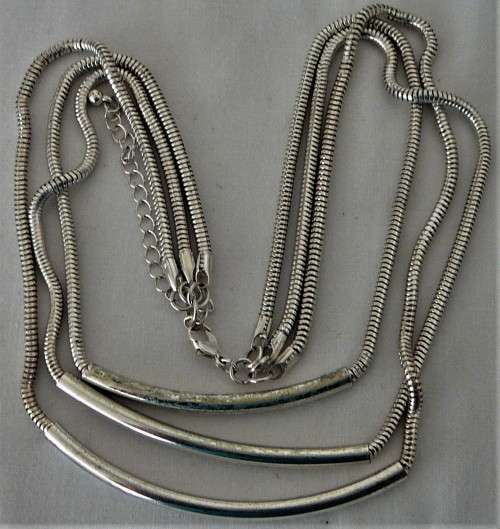 An Elegant Three Chain Silver Coloured Necklace
