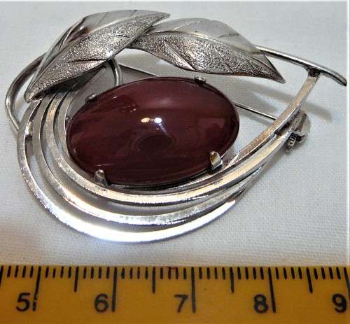 A Really Nice Silver Coloured  Brooch set with an Amber Coloured Stone