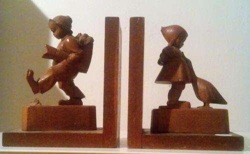 Hand carved Italian bookends with Hummel inspired children decoration.Signed.