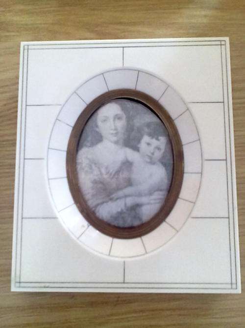 Vintage quality ivorine frame with picture of a mother and her child.