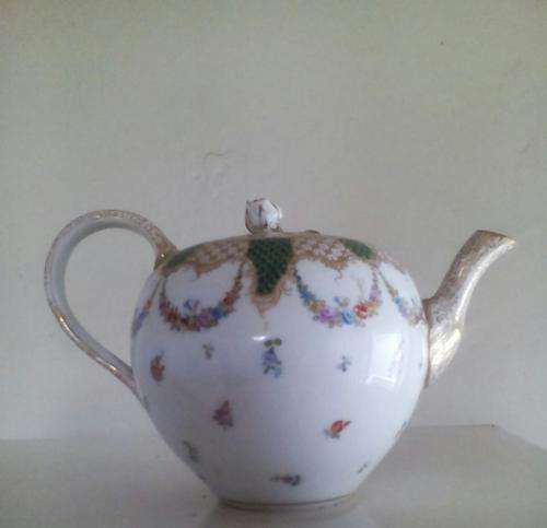 Exquisite fine porcelain teapot by Meissen, chip to handle.