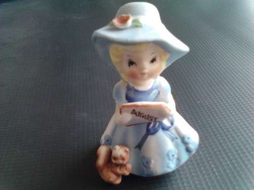 PORCELAIN FIGURINE - AUGUST GIRL, ORIGIN UNCERTAIN -READ BELOW.