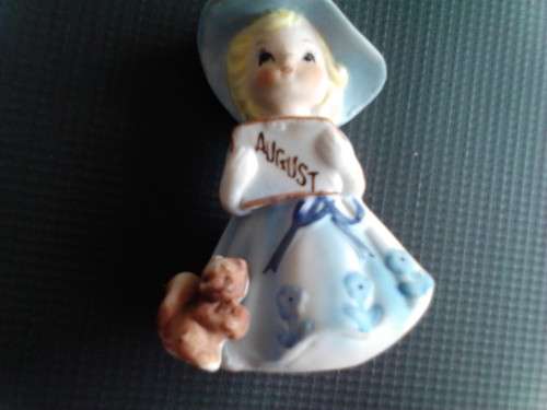 PORCELAIN FIGURINE - AUGUST GIRL, ORIGIN UNCERTAIN -READ BELOW.