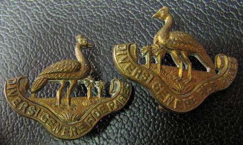 circa. WWII Northern Rhodesia Regiment cap badges, Left & Right facing - brass with vertical lugs