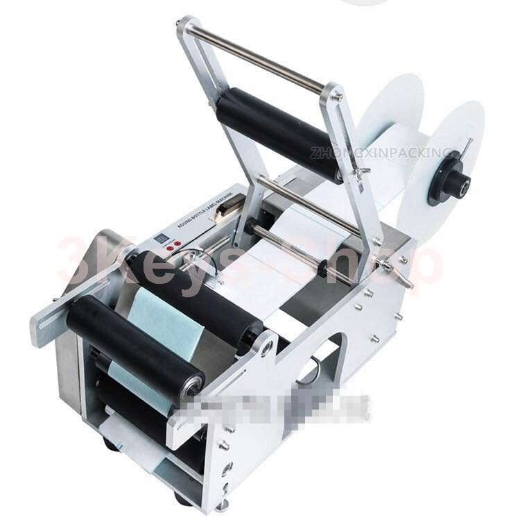 Automatic labeling machine for round bottles