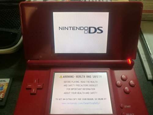 Red Nintendo DS Lite and 4 Games
