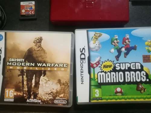 Red Nintendo DS Lite and 4 Games