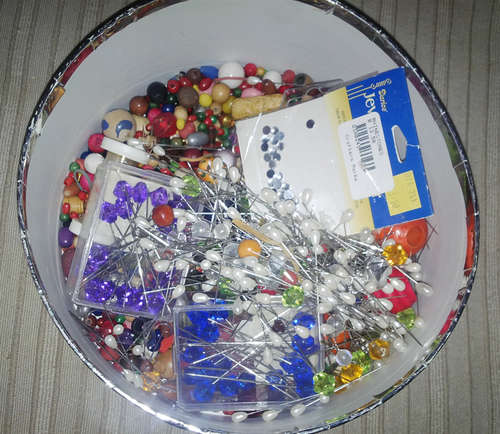 ROUND BOX FULL OF HAT PINS AND BEADS