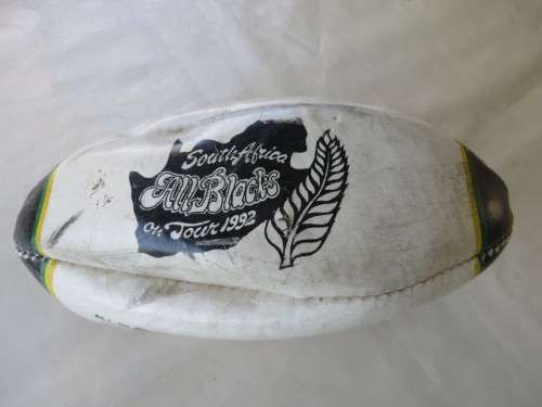 SMALL DEFLATED RUGBY BALL - 240 MM WIDE - SOUTH AFRICA / ALL BLACKS ON TOUR 1992 - AS PER SCAN