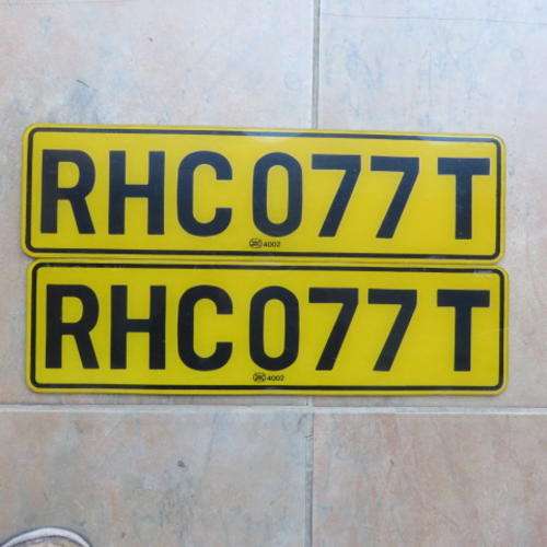 A PAIR OF PLASTIC NUMBER PLATES - RHC 077 T