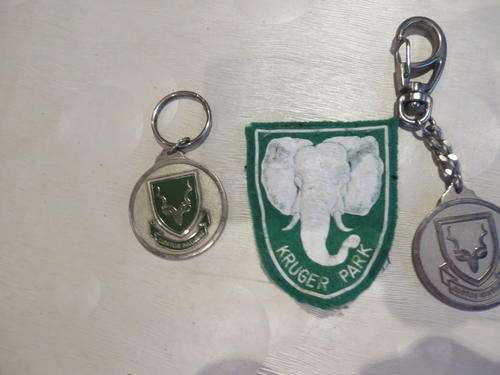 KRUGER PARK CLOTH BADGE AND TWO NATIONAL PARKS BOARD KEY HANGERS - AS PER SCAN