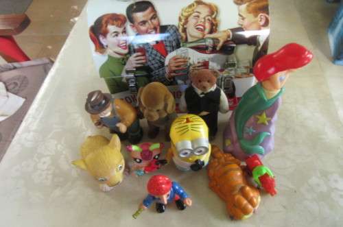 10 highly collectable toys in slightly dented coca cola lunch box