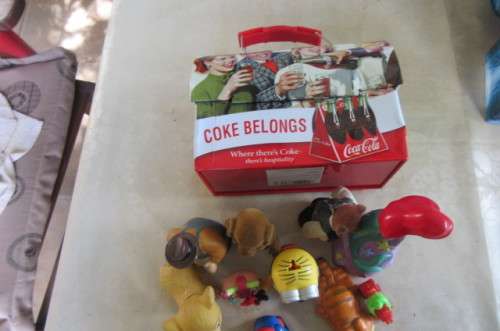 10 highly collectable toys in slightly dented coca cola lunch box