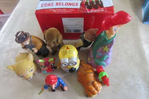 10 highly collectable toys in slightly dented coca cola lunch box