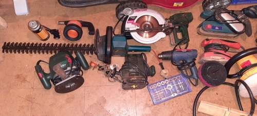 A STORE ROOM FULL OF TOOLS, SHELFS, TABLES, BOLTS, NUTS, SCREWS, SPANNERS ETC