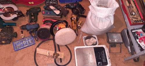 A STORE ROOM FULL OF TOOLS, SHELFS, TABLES, BOLTS, NUTS, SCREWS, SPANNERS ETC