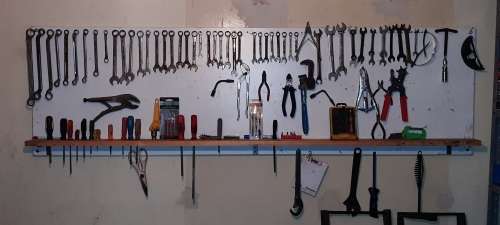 A STORE ROOM FULL OF TOOLS, SHELFS, TABLES, BOLTS, NUTS, SCREWS, SPANNERS ETC