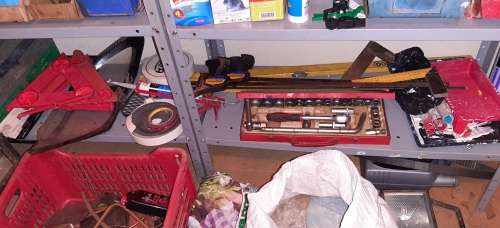 A STORE ROOM FULL OF TOOLS, SHELFS, TABLES, BOLTS, NUTS, SCREWS, SPANNERS ETC