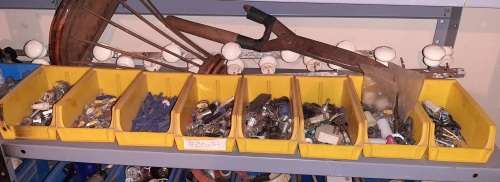 A STORE ROOM FULL OF TOOLS, SHELFS, TABLES, BOLTS, NUTS, SCREWS, SPANNERS ETC