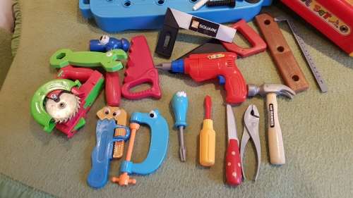 Kids Toy Tool bench in two parts with a variety of plastic tools and toolbox.