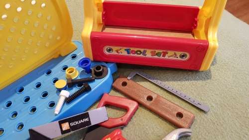 Kids Toy Tool bench in two parts with a variety of plastic tools and toolbox.