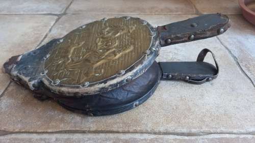 Antique Bellows. Wood covered in leather with round embossed brass plate