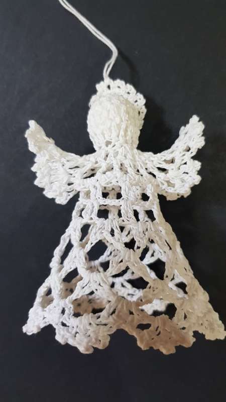 Christmas decoration. Small Christmas tree angel in white crochet thread