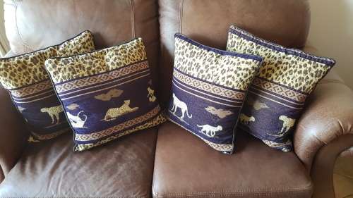 Vintage Scatter cushion:  Leopards on Brown background, with a broad African print at the top.