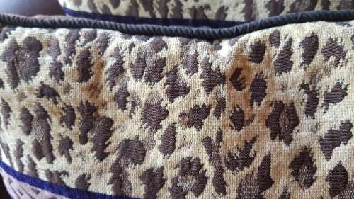 Vintage Scatter cushion:  Leopards on Brown background, with a broad African print at the top.