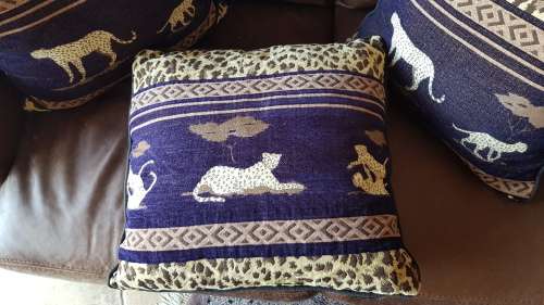 Vintage Scatter cushion:  Leopards on Brown background, with a broad African print at the top.