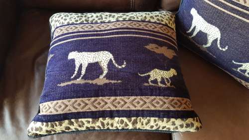 Vintage Scatter cushion:  Leopards on Brown background, with a broad African print at the top.