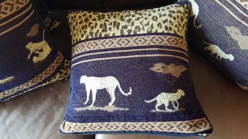 Vintage Scatter cushion:  Leopards on Brown background, with a broad African print at the top.