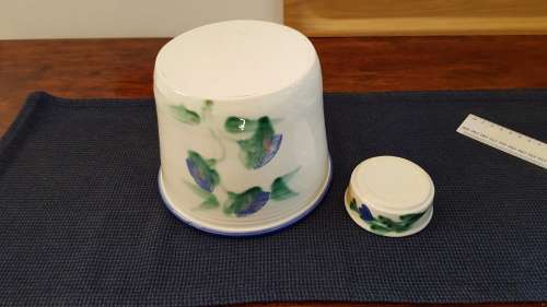 Indoor flower pot/planter. Ceramic glazed flower pot white with blue trim on rim and a blue flower
