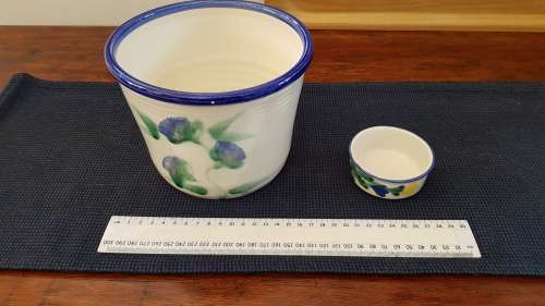 Indoor flower pot/planter. Ceramic glazed flower pot white with blue trim on rim and a blue flower
