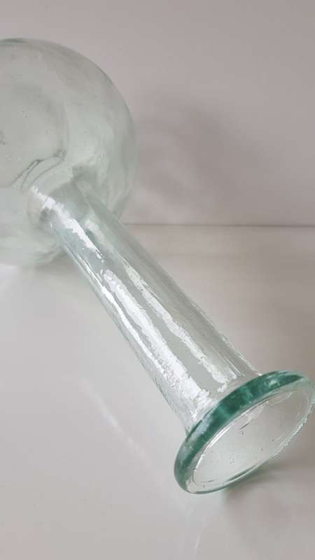 Glass Flower vase. Long thin necked glass vase with round base. Glass has small air bubbles.