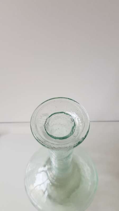 Glass Flower vase. Long thin necked glass vase with round base. Glass has small air bubbles.
