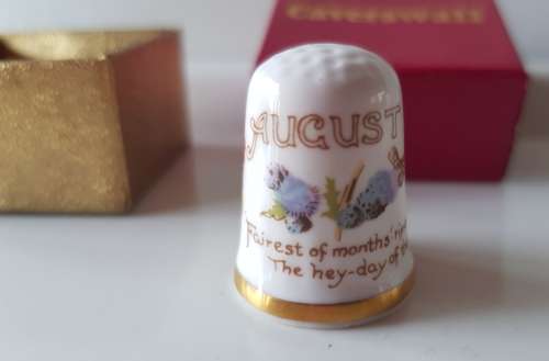 A Caverswall Fine Bone China collectors thimble in original presentation box.