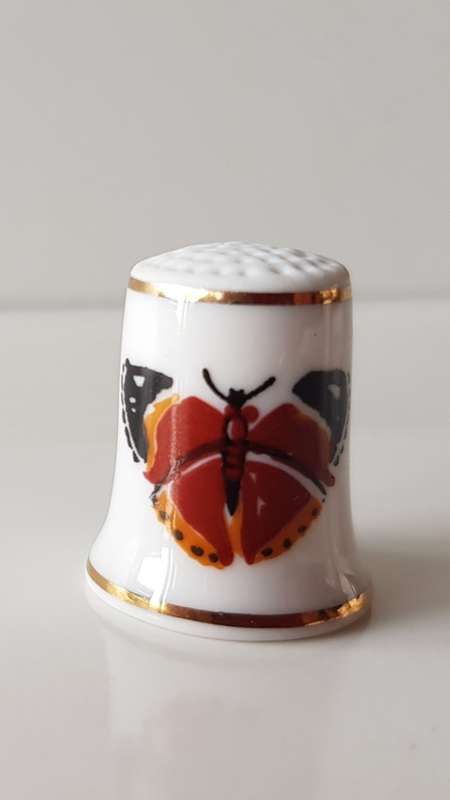 A Vintage collectors thimble. Thimble has two painted butterflies