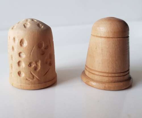 A Vintage collectors set of two wooden thimbles. Two Hand crafted wooden Thimbles.