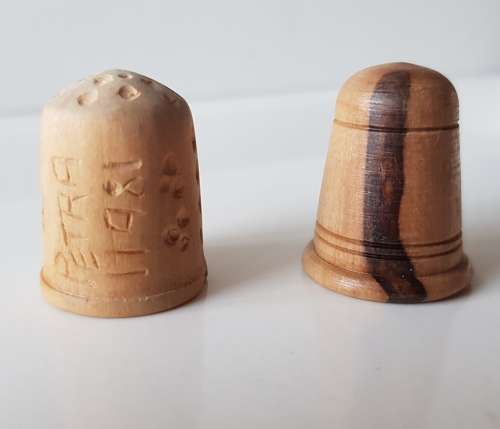 A Vintage collectors set of two wooden thimbles. Two Hand crafted wooden Thimbles.