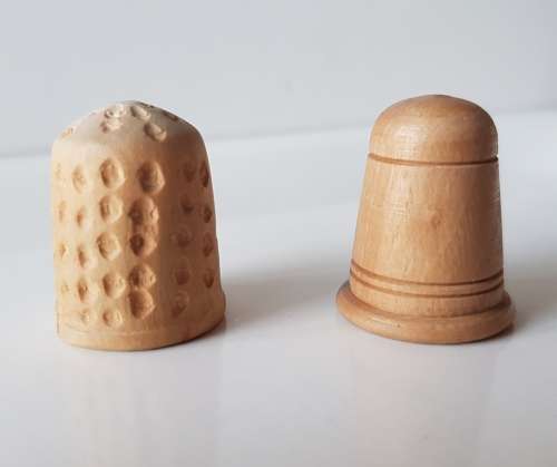 A Vintage collectors set of two wooden thimbles. Two Hand crafted wooden Thimbles.