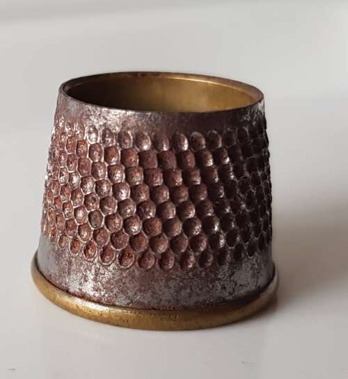 A Vintage collectors nickel-plated steel thimble. The Thimble is an open-ended tailors thimble