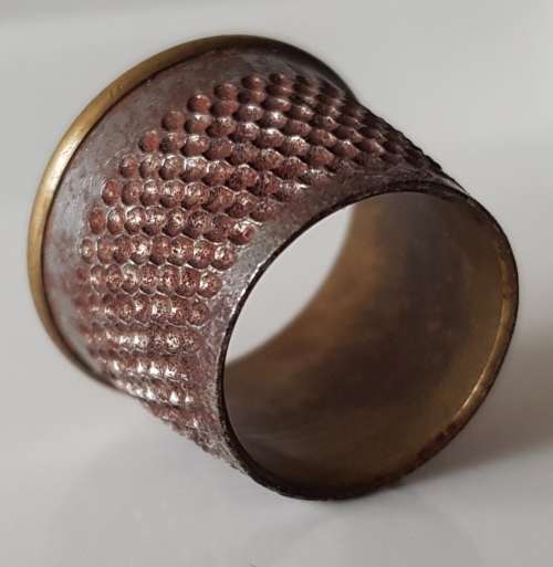 A Vintage collectors nickel-plated steel thimble. The Thimble is an open-ended tailors thimble