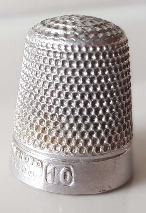 A Vintage collectors aluminium thimble. Thimble is marked with a number 2 and the name Stratnoid