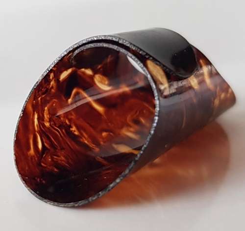 A Vintage collectors Perspex plastic thimble. Thimble is brown coloured plastic & expandable rinG