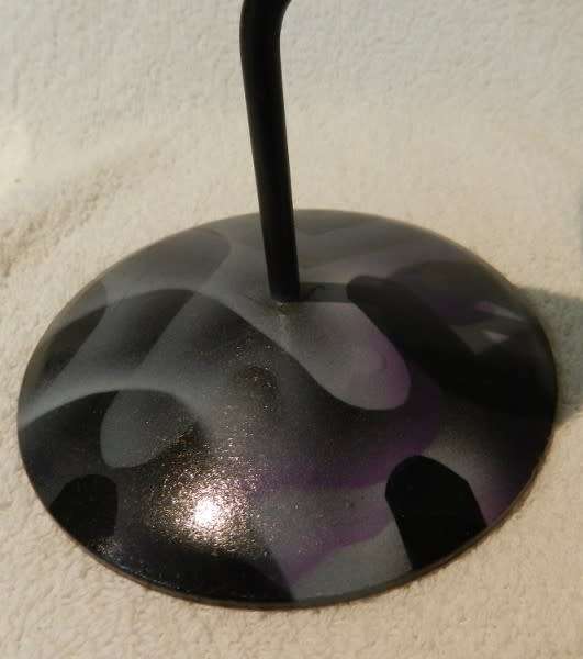 Desk standing clock, twisted iron with coloured base and a CD disc clock face.